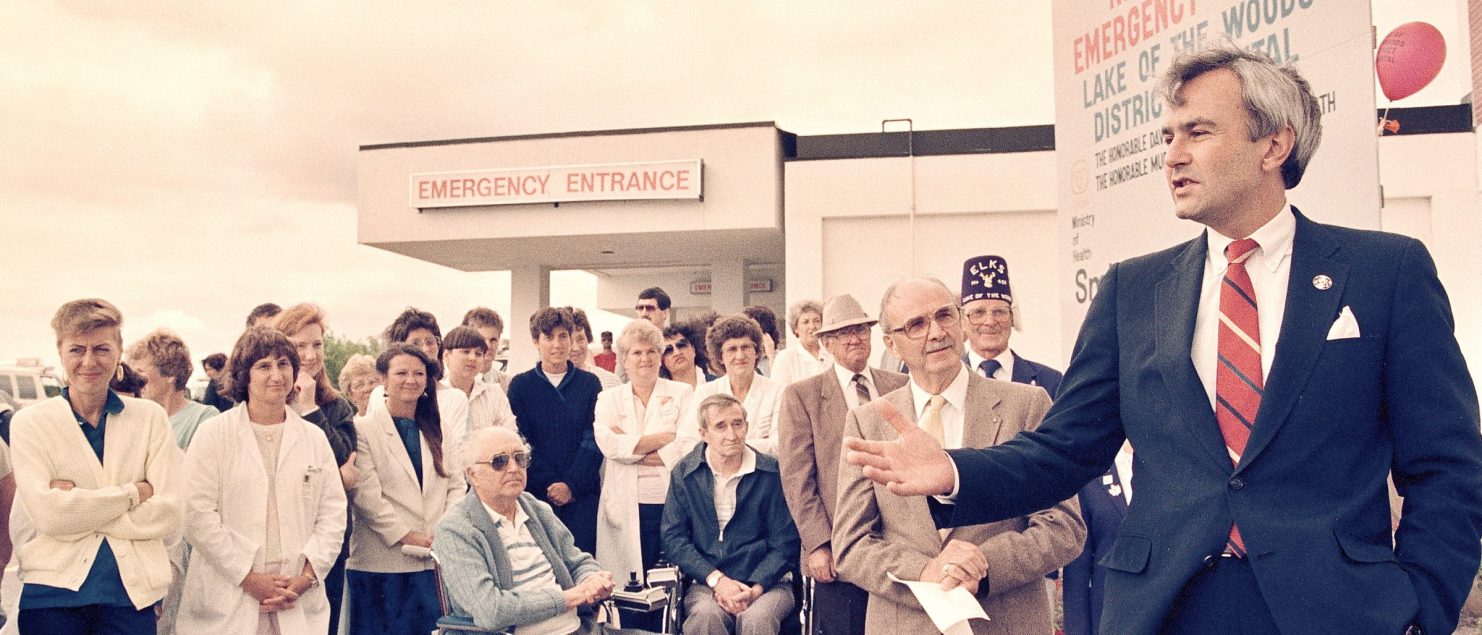 Peterson speaks to a crowd in front of health care facility in Lake of the Woods